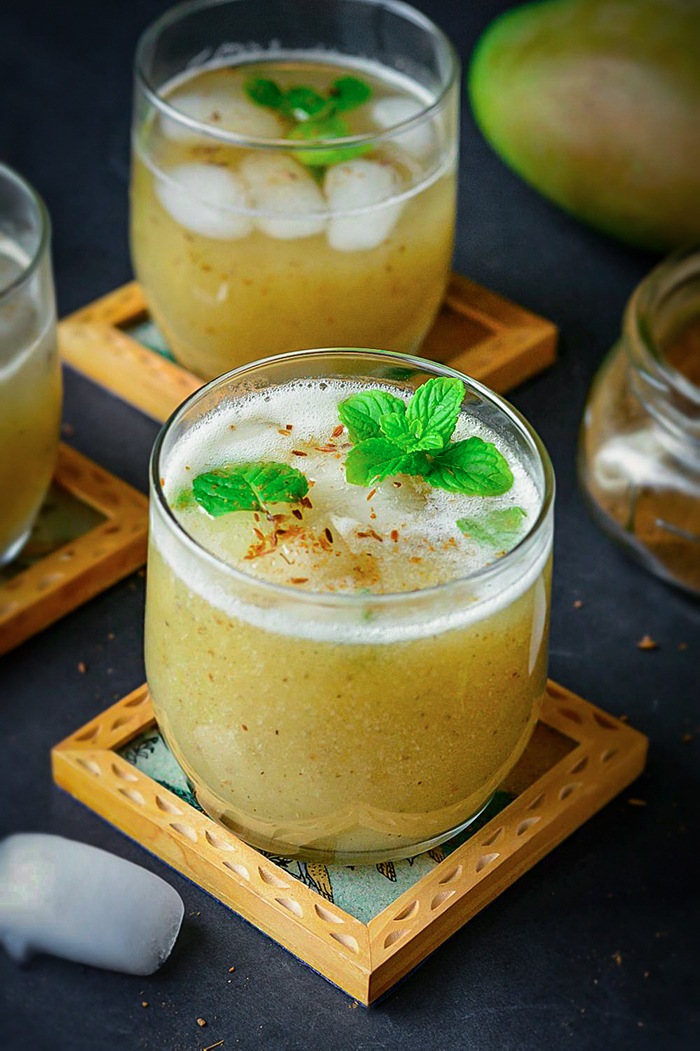 Aam ka panna on a coaster with mint leaves