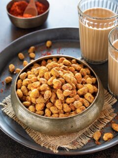 Achari Masala Peanuts with tea in a bowl