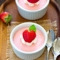 Eggless Strawberry Mousse with strawberry on top and mint leaves