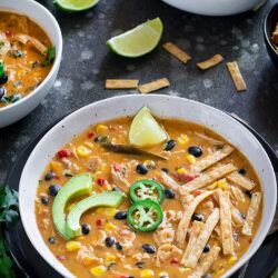Instant Pot Creamy Chicken Tortilla Soup in a bowl garnished with avocados