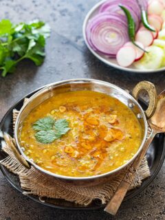Instant Pot Panchmel dal with rice and onions in a bowl