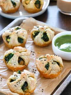 Palak Paneer puffs garnished with black sesame seeds