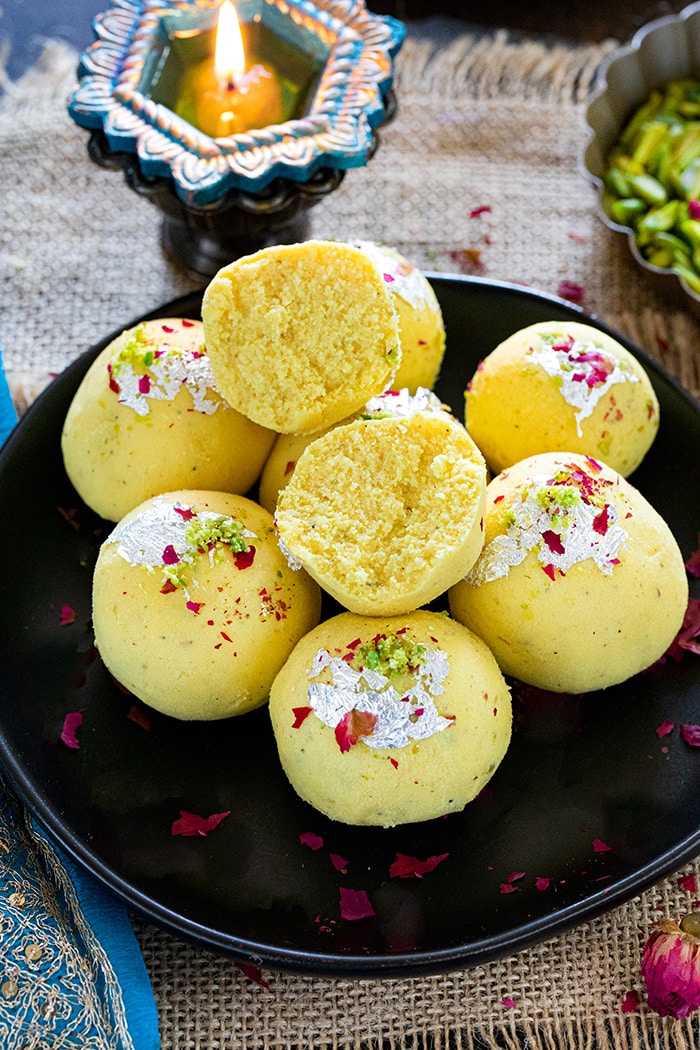 Paneer Malai Ladoo on a plate garnished with rose leaves
