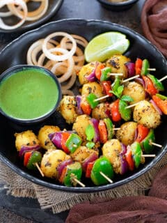Tandoori aloo tikka on toothpick served as a platter