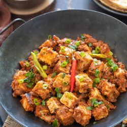 Tawa paneer in a bowl garnished with scallions