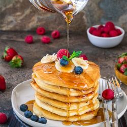 Vegan Coconut Banana pancakes drizzled with maple syrup